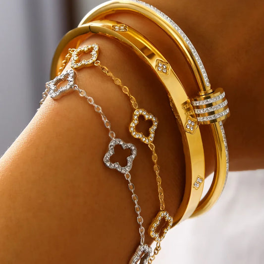 Gold and silver bracelet set on a wrist with a neutral background